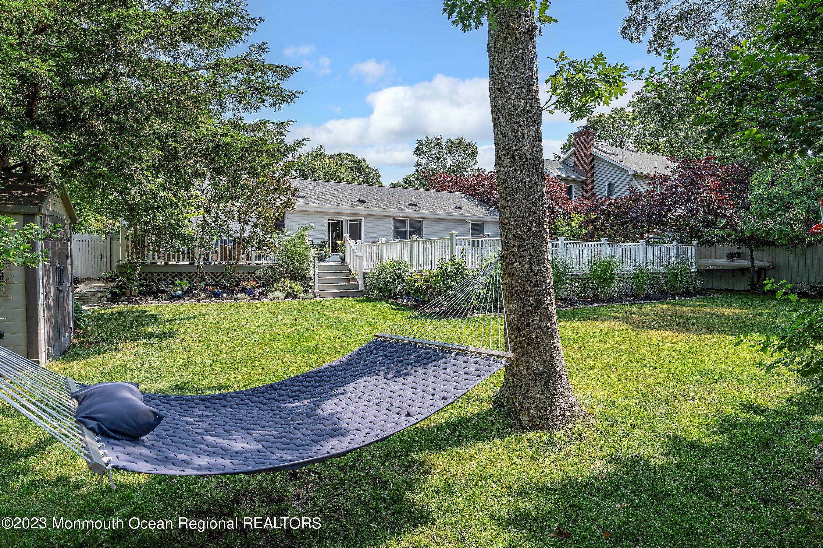 653 Carroll Fox Road Brick, NJ 08724 - Photo 23 of 48 a view of a house with a yard deck and a patio