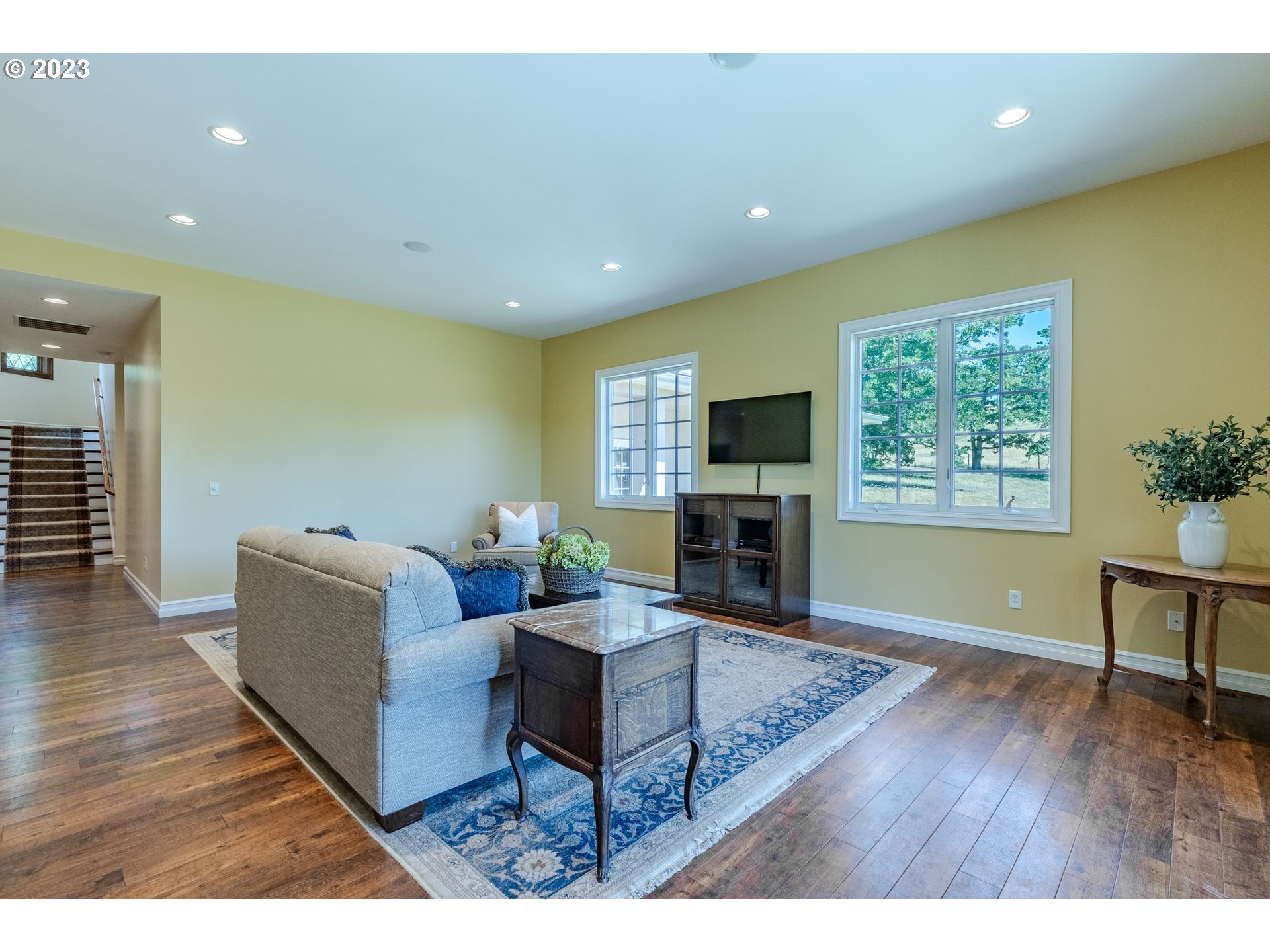 86705 Pine Grove Road Eugene, OR 97402 - Photo 29 of 48 a living room with furniture a fireplace and a flat screen tv