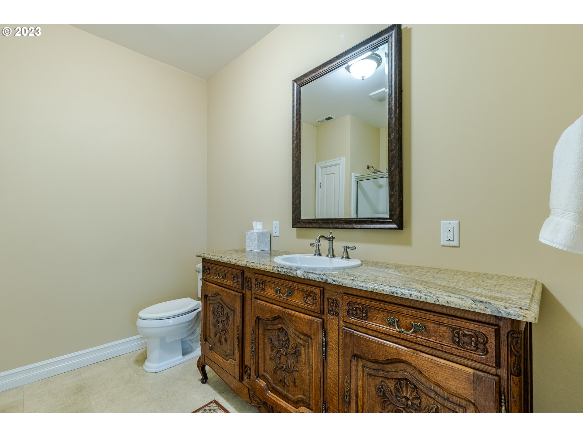 86705 Pine Grove Road Eugene, OR 97402 - Photo 35 of 48 a bathroom with a granite countertop toilet a sink and a mirror