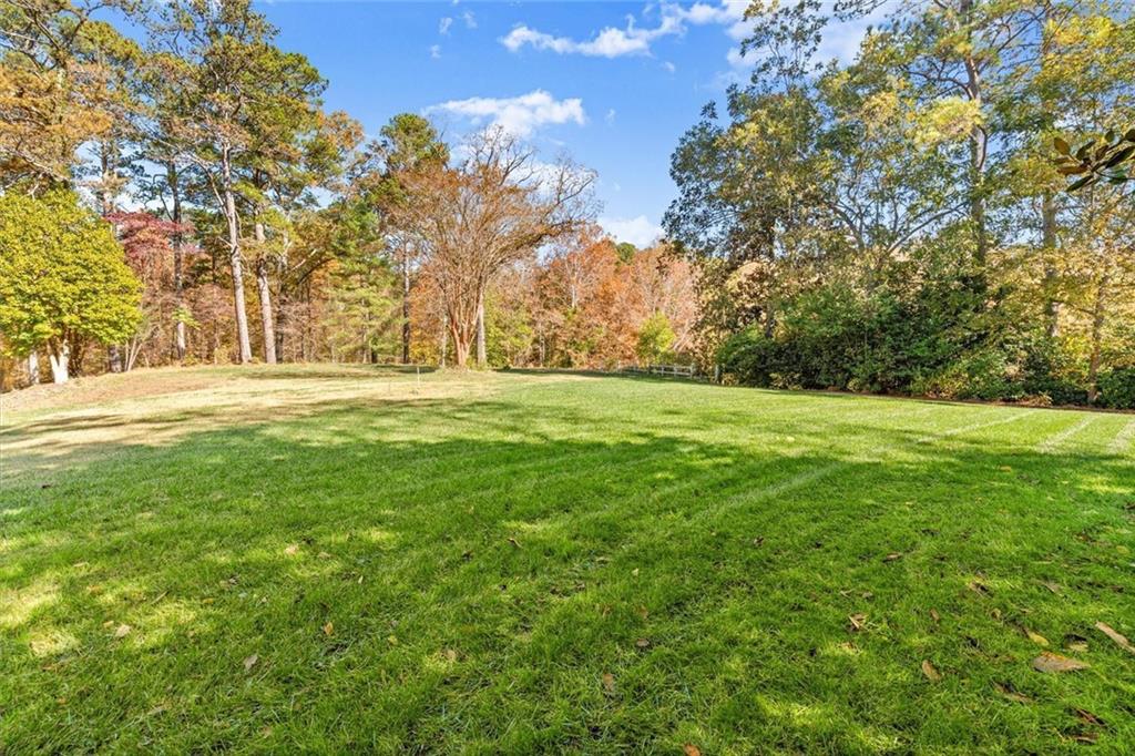 1099 Burnt Hickory Road Northwest Marietta, GA 30064 - Photo 11 of 17 a view of a field with trees in the background