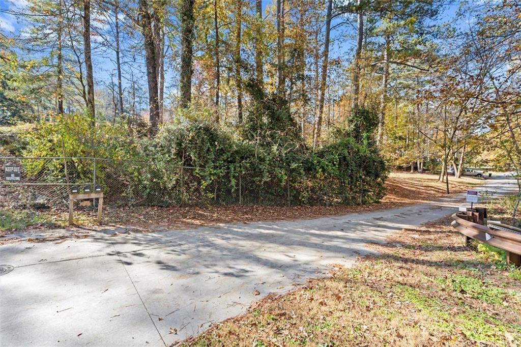 1099 Burnt Hickory Road Northwest Marietta, GA 30064 - Photo 5 of 17 a view of a yard with plants and trees