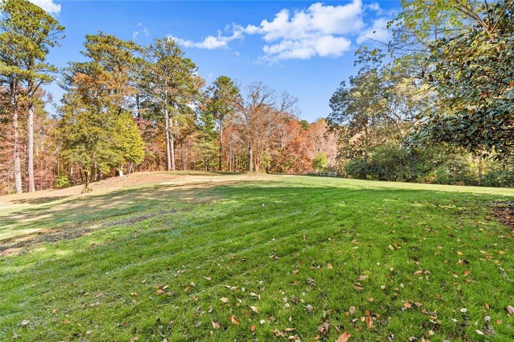 1099 Burnt Hickory Road Northwest Marietta, GA 30064 - Photo 10 of 17 a backyard of a house with lots of green space