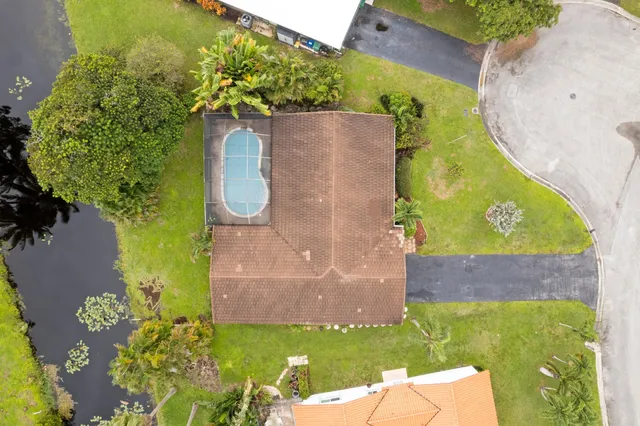 an aerial view of a house with a yard