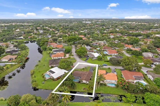 an aerial view of residential houses with outdoor space and swimming pool
