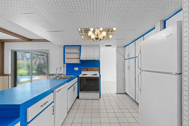 a kitchen with stainless steel appliances a refrigerator and a sink