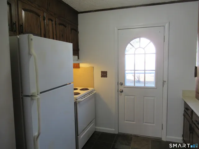 a white refrigerator freezer and a dishwasher in a kitchen