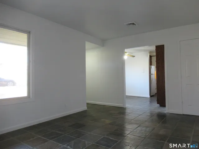 an empty room with windows and closet