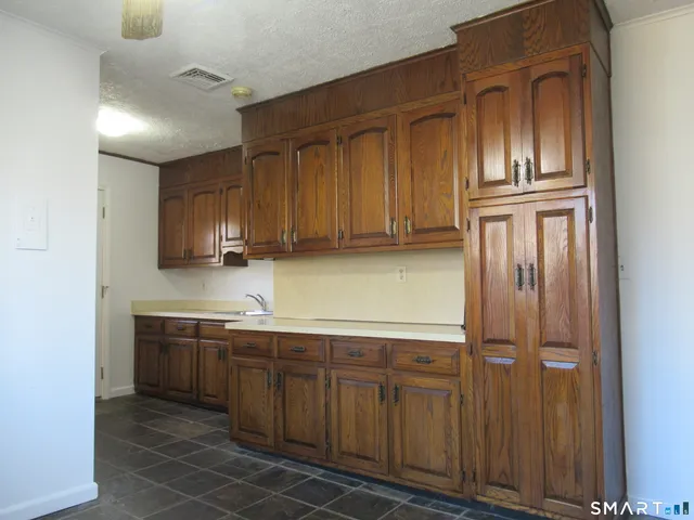 a kitchen with stainless steel appliances granite countertop a refrigerator and cabinets