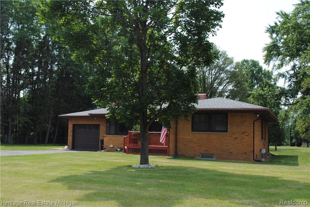 Front of home sheltered by towering trees!