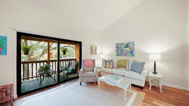 a living room with furniture and a floor to ceiling window