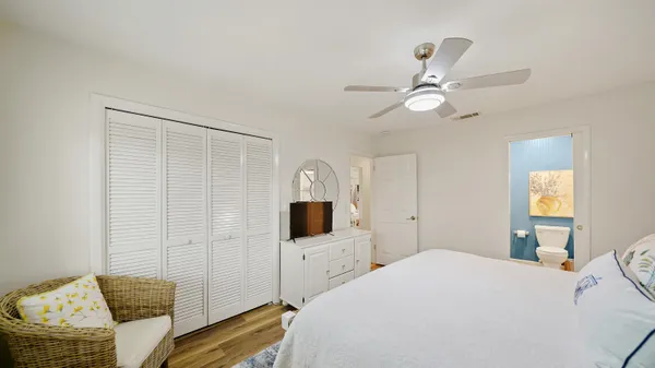 a bedroom with a bed window and a flat screen tv