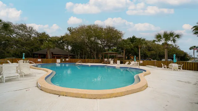 a view of a swimming pool with outdoor seating