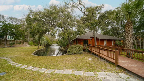 a backyard of a house with table and chairs