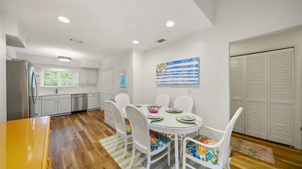 a view of a dining room with furniture and a wooden floor
