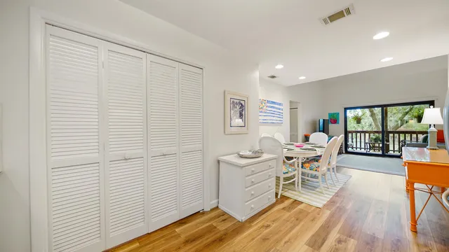 a living room with furniture floor to ceiling window and wooden floor