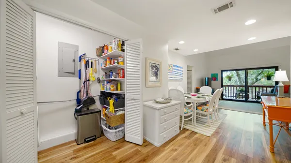 a living room with furniture a rug and a book shelf