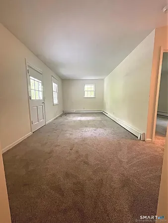 an empty room with windows and closet