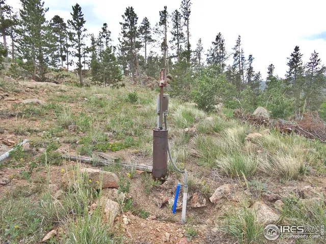 a view of a large building with mountains in the background