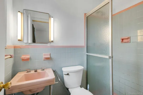 a bathroom with a sink mirror and toilet
