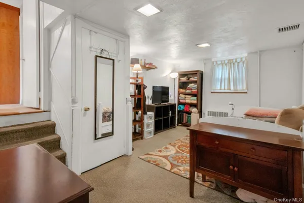 a view of kitchen with stainless steel appliances granite countertop a refrigerator and a stove top oven