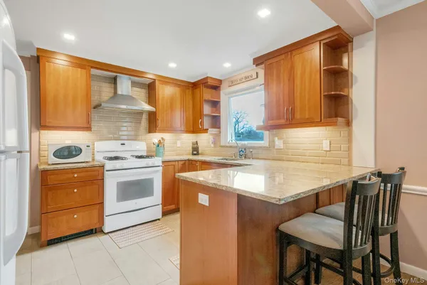 a kitchen with a stove a sink and a refrigerator