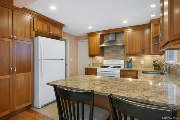 a kitchen with kitchen island a counter top space cabinets and stainless steel appliances