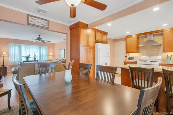 a dining room with furniture a chandelier and wooden floor