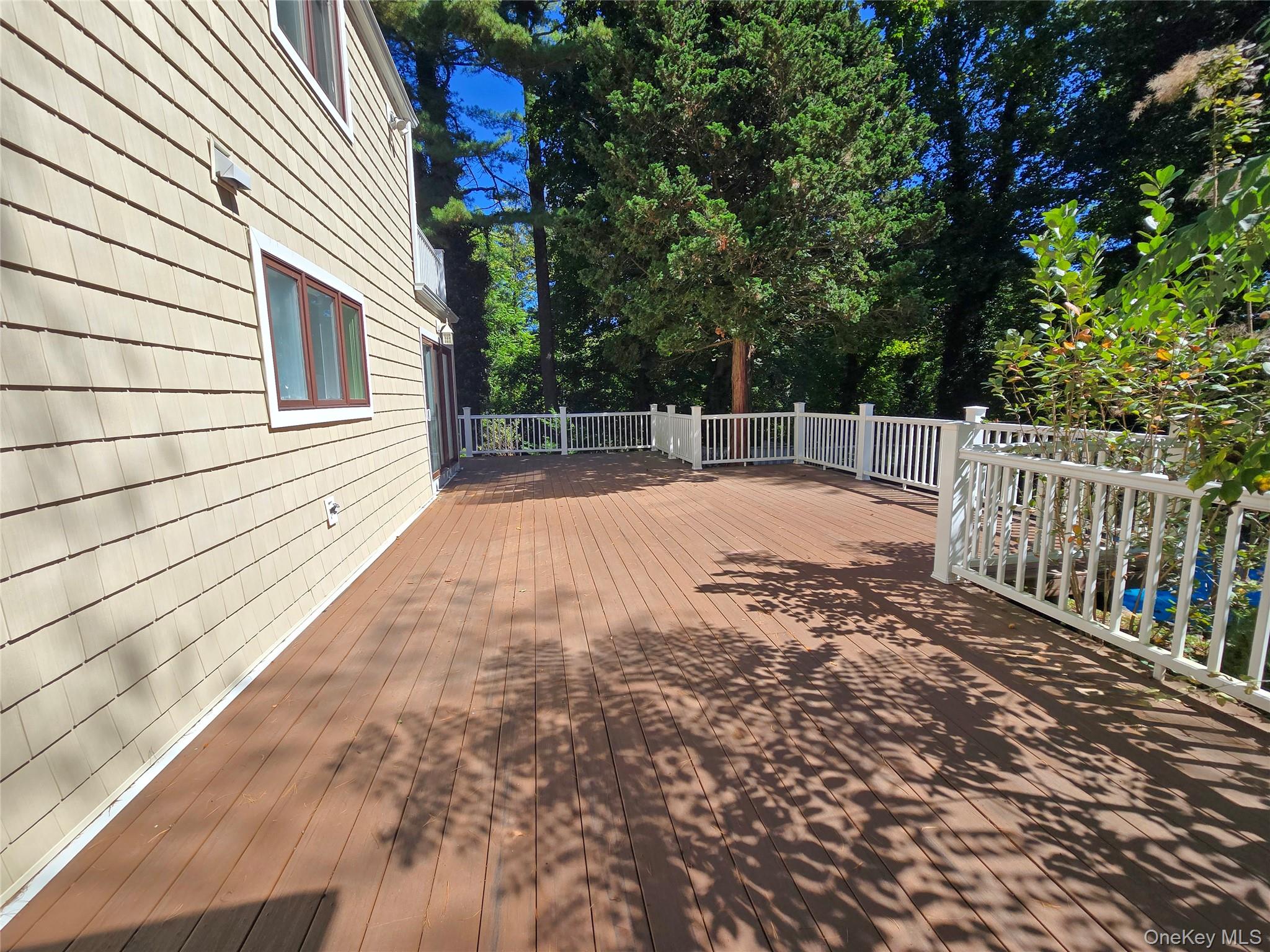 32 Valley Road Old Westbury, NY 11568 - Photo 11 of 45 Deck with view of wooded area