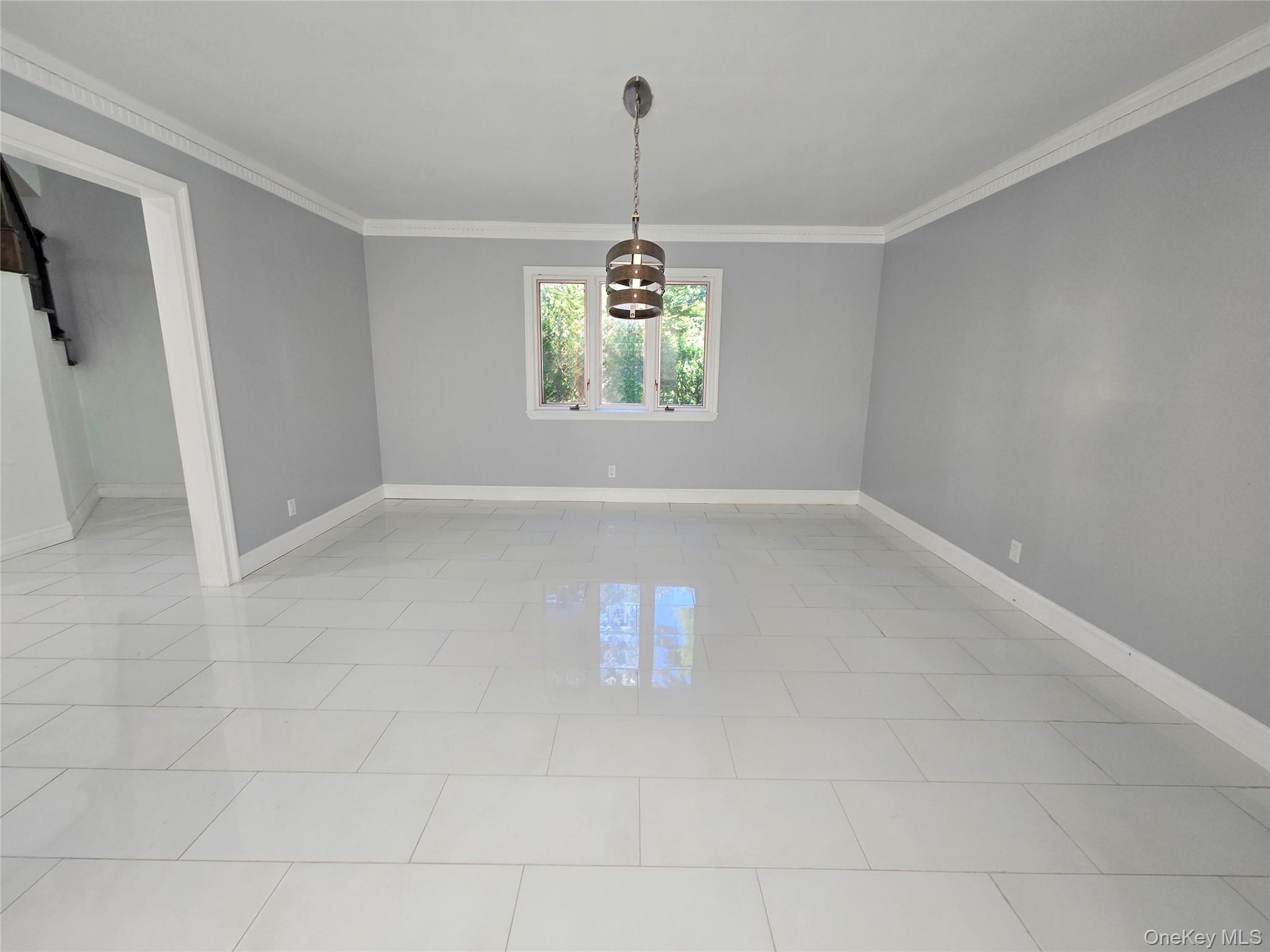32 Valley Road Old Westbury, NY 11568 - Photo 16 of 45 Spare room featuring light tile patterned floors and ornamental molding