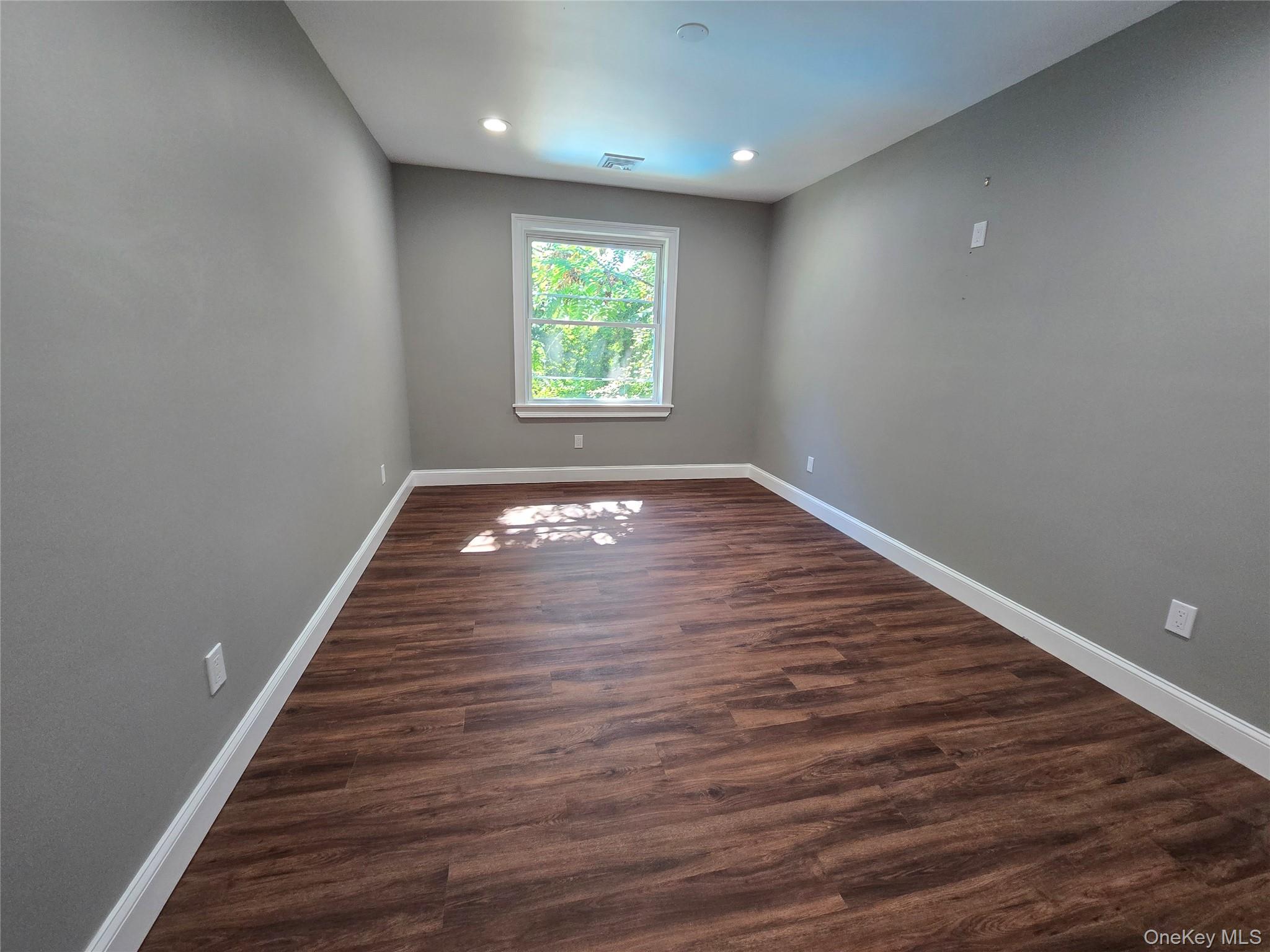 32 Valley Road Old Westbury, NY 11568 - Photo 17 of 45 Spare room with dark wood-type flooring and recessed lighting