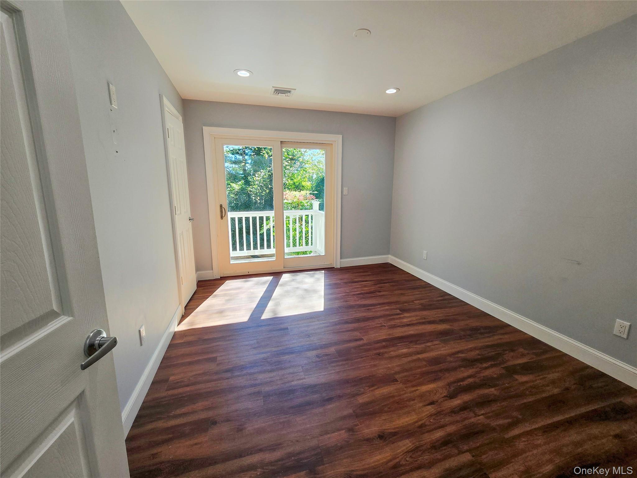 32 Valley Road Old Westbury, NY 11568 - Photo 18 of 45 Spare room featuring dark wood finished floors and recessed lighting