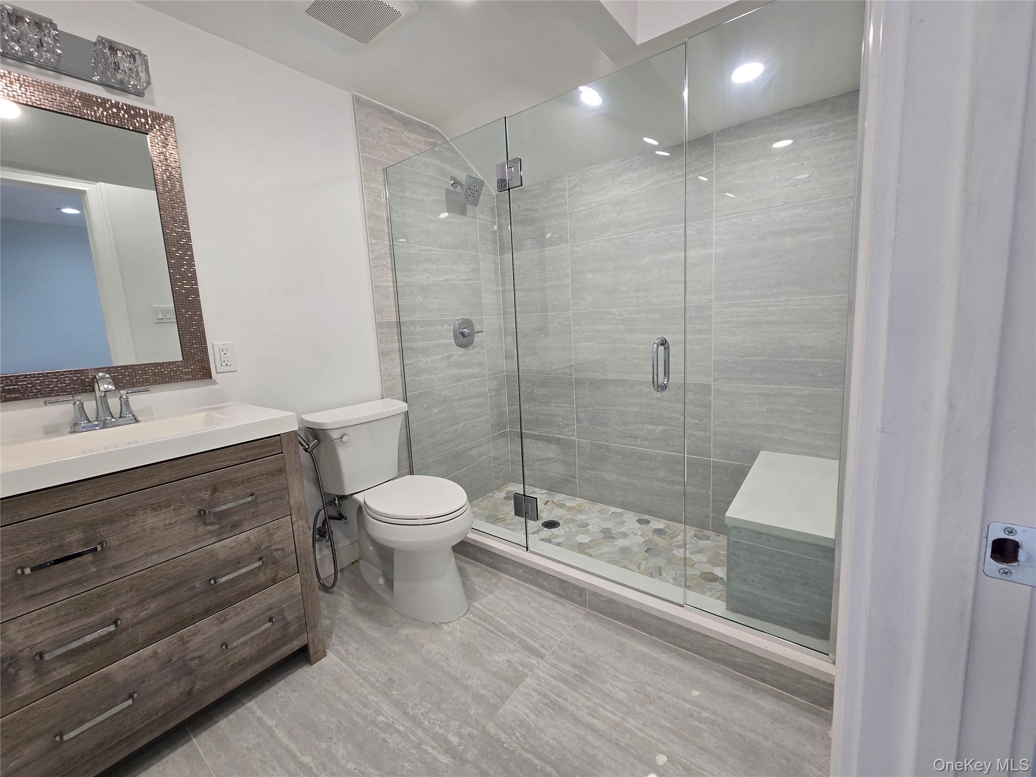 32 Valley Road Old Westbury, NY 11568 - Photo 21 of 45 Bathroom featuring a shower stall, vanity, recessed lighting, and light tile patterned floors