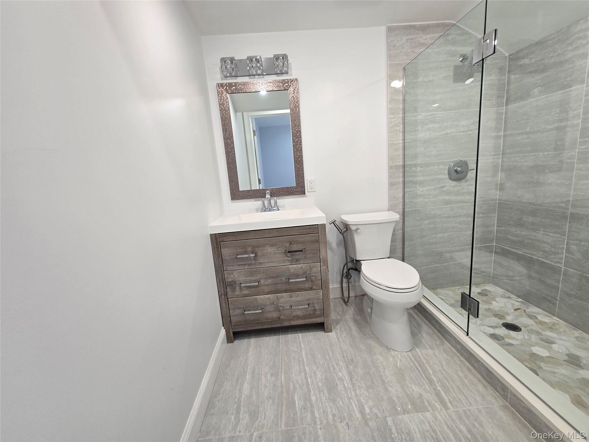 32 Valley Road Old Westbury, NY 11568 - Photo 22 of 45 Bathroom with a shower stall and vanity