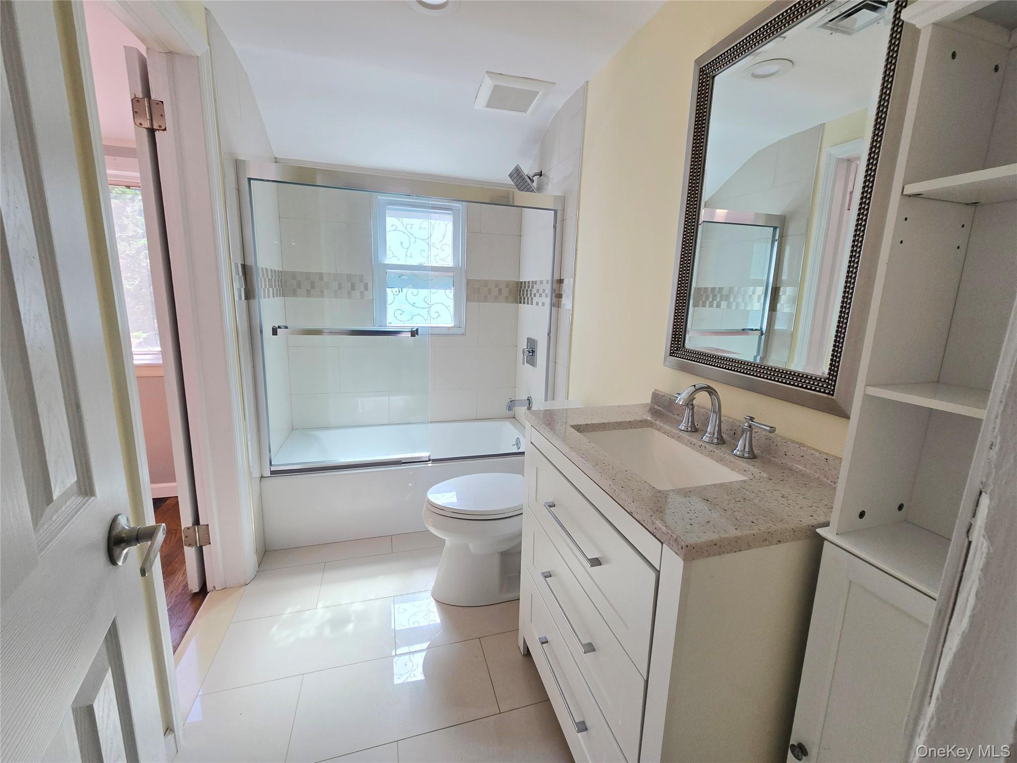32 Valley Road Old Westbury, NY 11568 - Photo 23 of 45 Bathroom with bath / shower combo with glass door, vanity, and light tile patterned floors
