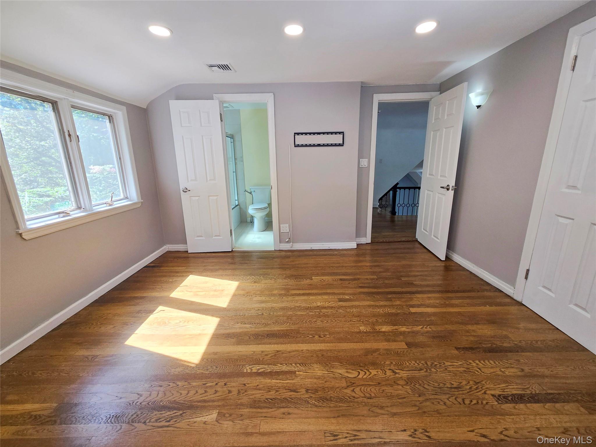 32 Valley Road Old Westbury, NY 11568 - Photo 26 of 45 Unfurnished bedroom with recessed lighting, dark wood-style flooring, and ensuite bath