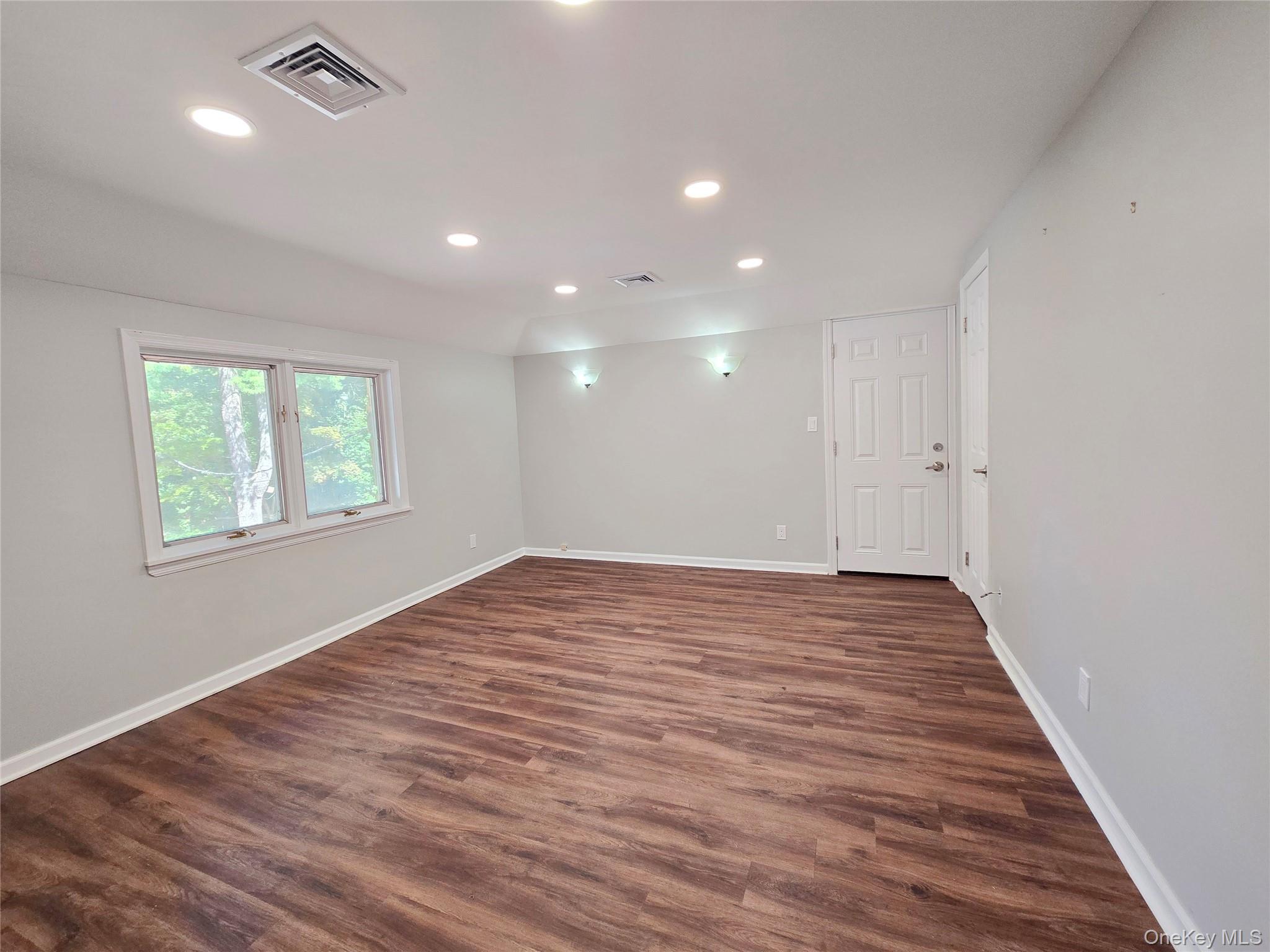 32 Valley Road Old Westbury, NY 11568 - Photo 28 of 45 Spare room with recessed lighting and dark wood-style floors