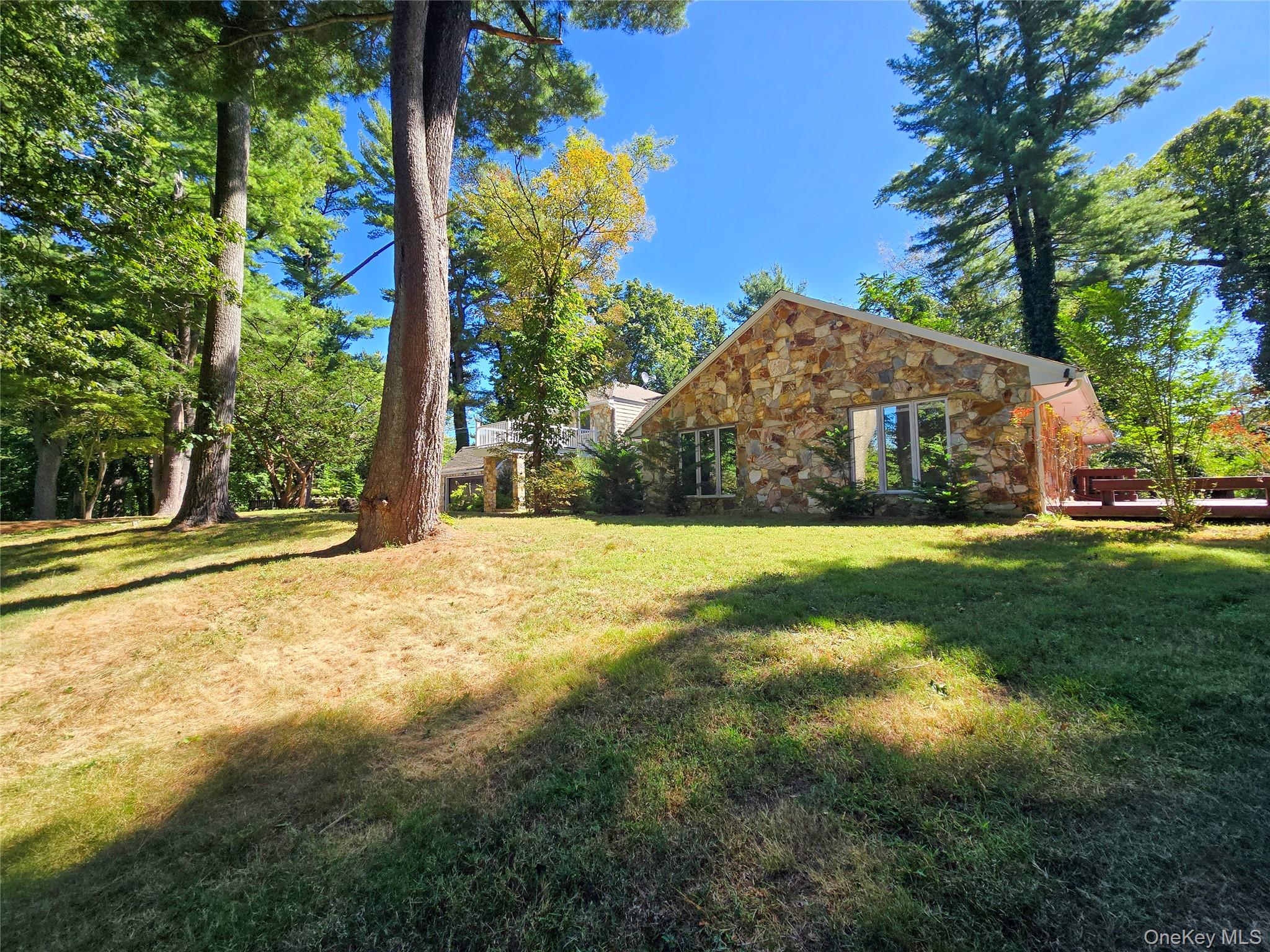32 Valley Road Old Westbury, NY 11568 - Photo 3 of 45 View of green lawn with a wooden deck