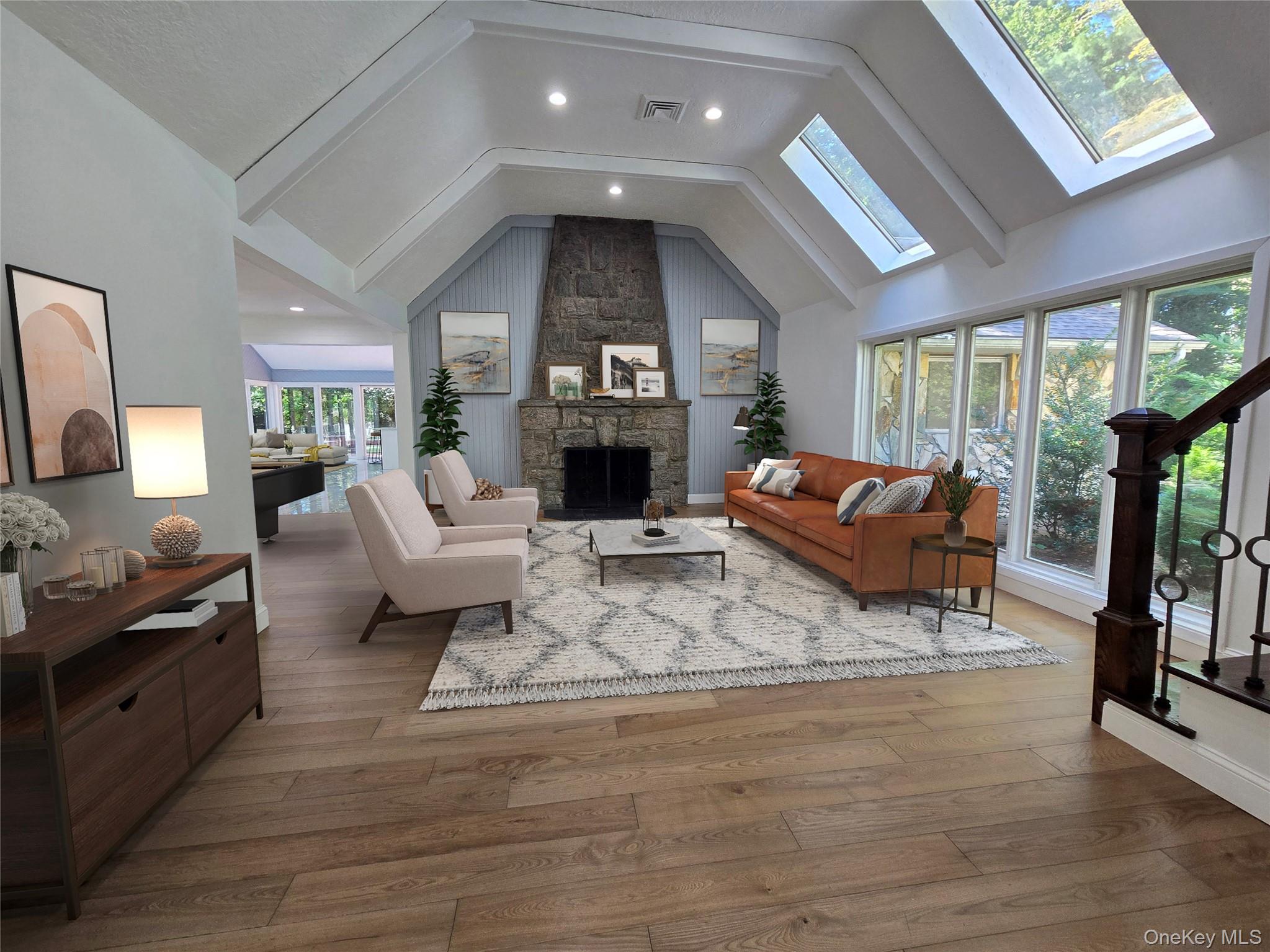 32 Valley Road Old Westbury, NY 11568 - Photo 33 of 45 Living area featuring hardwood / wood-style floors, a stone fireplace, a skylight, recessed lighting, and stairway