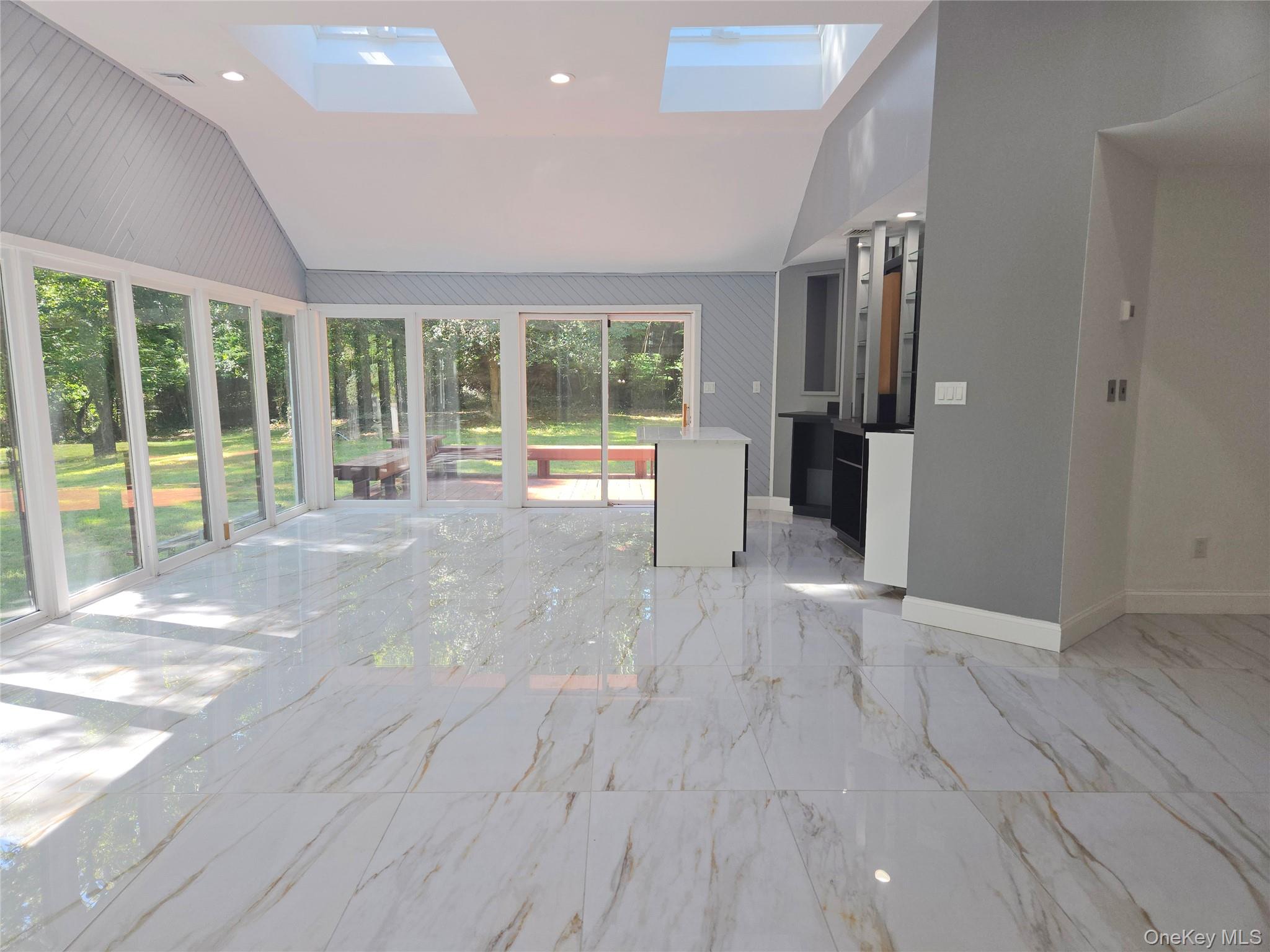 32 Valley Road Old Westbury, NY 11568 - Photo 35 of 45 Unfurnished sunroom featuring lofted ceiling and a skylight