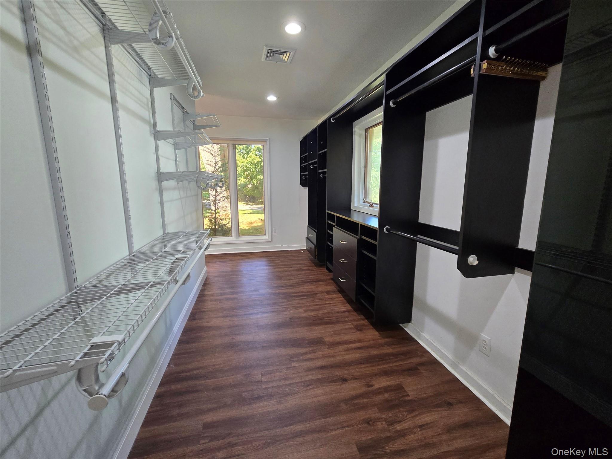 32 Valley Road Old Westbury, NY 11568 - Photo 39 of 45 Walk in closet featuring dark wood finished floors