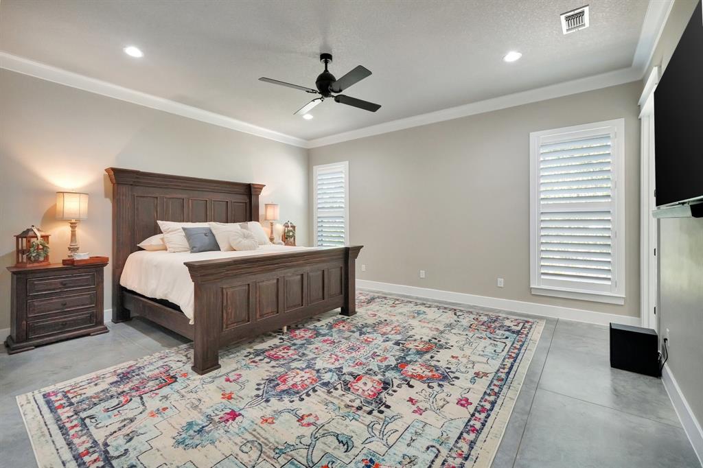 516 West Spring Street Weatherford, TX 76086 - Photo 13 of 39 a bedroom with a large bed and a chandelier