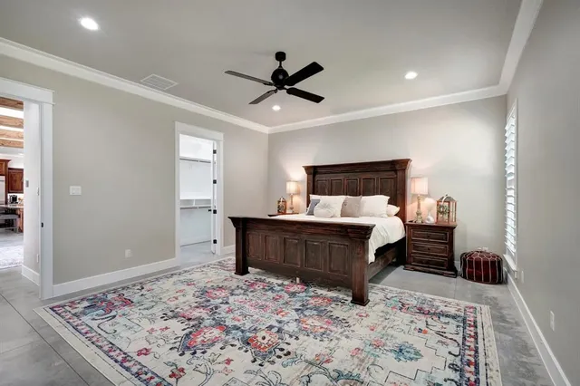 a bedroom with a bed tv and window