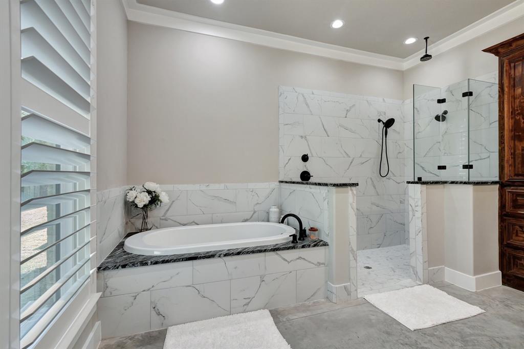 516 West Spring Street Weatherford, TX 76086 - Photo 16 of 39 a bathroom with a bathtub and a shower