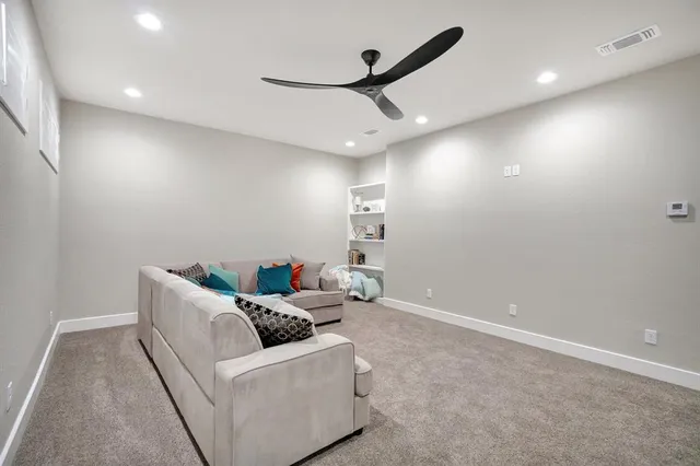 a spacious bedroom with a bed and a ceiling fan