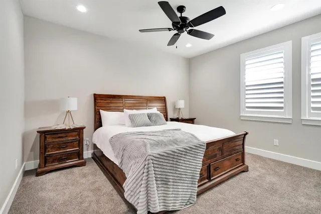 a bedroom with a bed and a ceiling fan