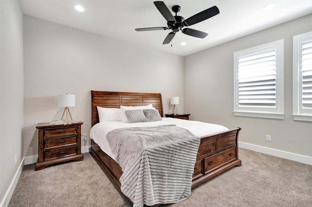 516 West Spring Street Weatherford, TX 76086 - Photo 22 of 39 a bedroom with a bed and ceiling fan