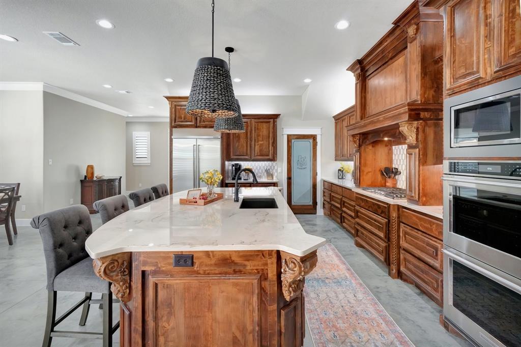 516 West Spring Street Weatherford, TX 76086 - Photo 7 of 39 a kitchen with stainless steel appliances wooden floor dining table and chairs