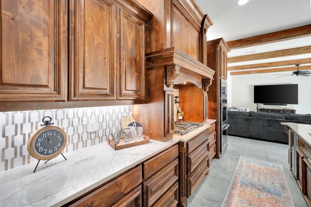 516 West Spring Street Weatherford, TX 76086 - Photo 8 of 39 a kitchen with stainless steel appliances granite countertop a sink and a stove with wooden floor