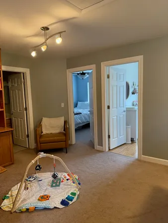 a bedroom with furniture and a lamp