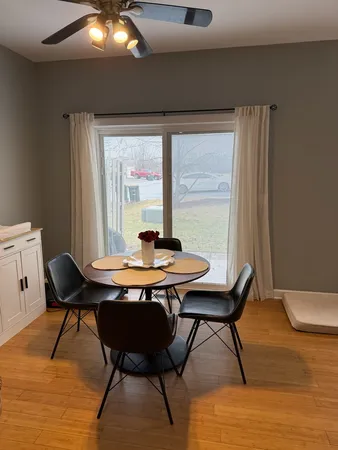 a view of a dining room with furniture and window